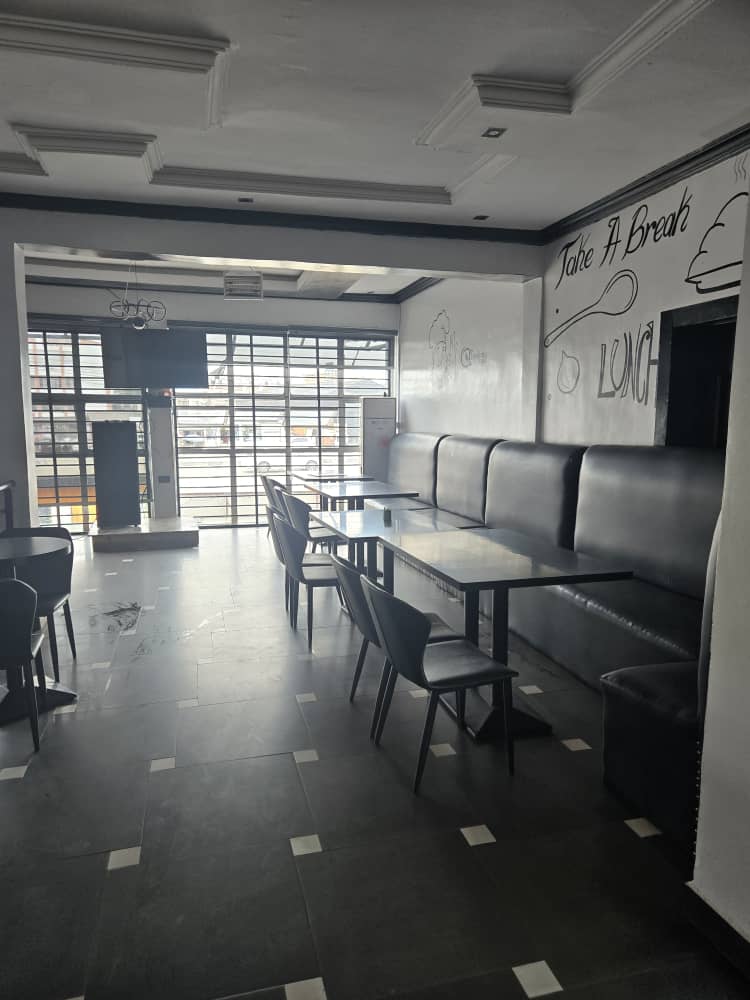 Dimly lit upscale restaurant interior with tables set for dinner